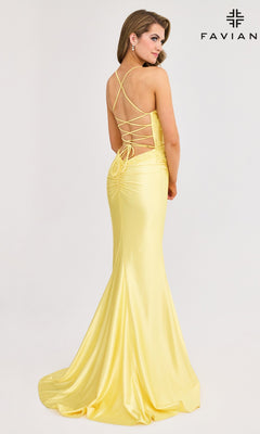 A woman faces away from the camera, wearing the Lace-Applique Faviana V-Neck Long Prom Dress 11010 in yellow satin with a lace-up open back. "Faviana" is shown in the top right corner against a plain background.