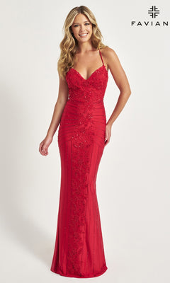 A woman wears the Lace-Up Long Faviana Beaded Prom Dress 11021, a fitted, floor-length gown with thin straps and intricate beadwork, standing against a plain white background with "FAVIAN" in the corner.