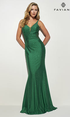 A woman stands against a white background wearing the Heat Stone Faviana Long Prom Dress 11022, a fitted green floor-length gown with beaded detailing and thin straps. "FAVIAN" appears in the top right corner.