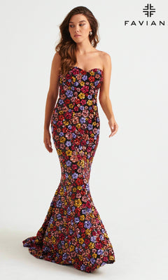 A woman models the Faviana Long Strapless Floral Prom Dress 11036, featuring colorful floral sequins and a plain backdrop with the FAVIAN logo—a stunning choice for any special occasion.