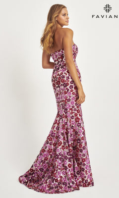 A woman poses in the Faviana Long Strapless Floral Prom Dress 11036, a floor-length gown with a fitted bodice and flared skirt, featuring sequin floral details in magenta and purple, set against a plain white background.