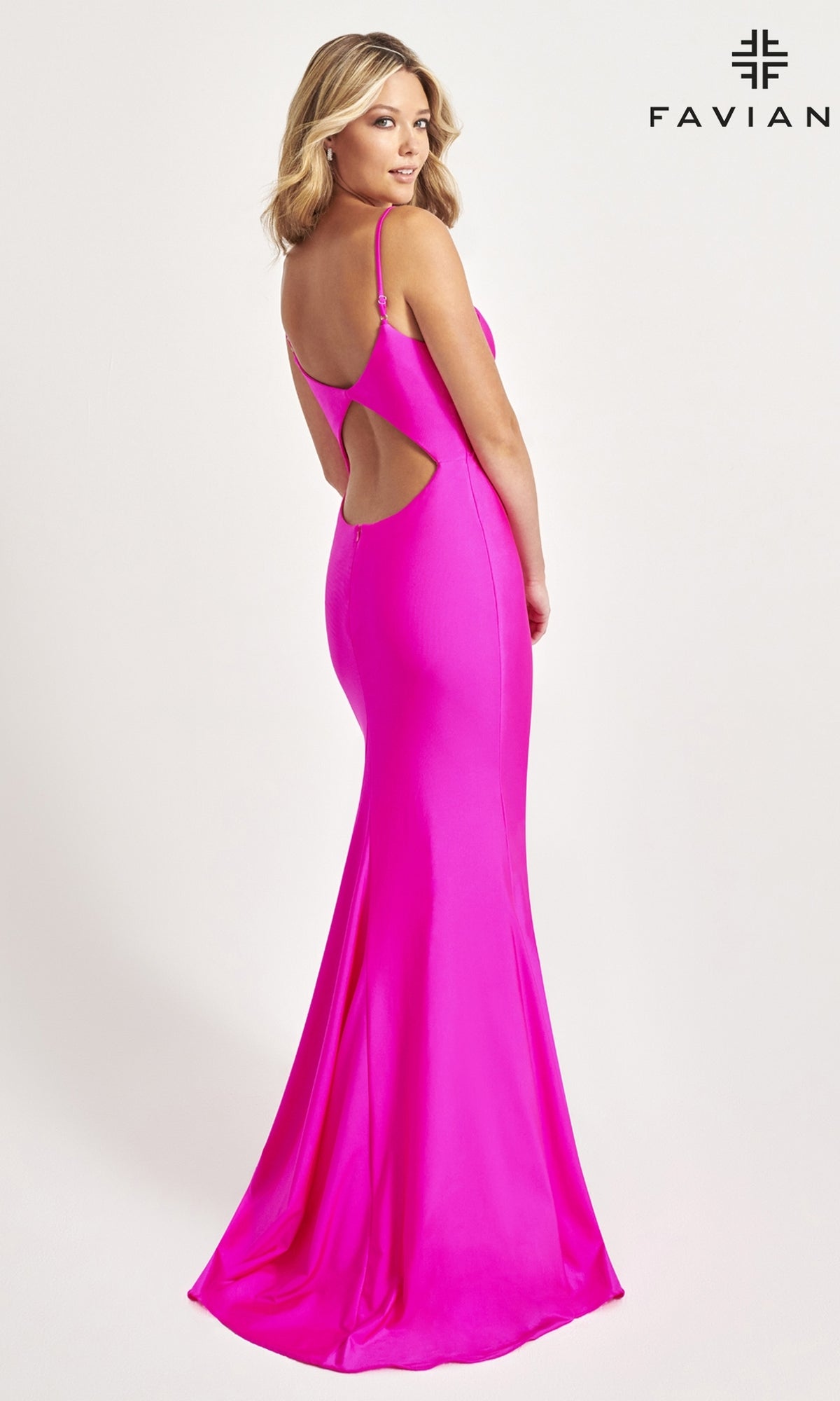 A woman poses in front of a plain background wearing the Faviana Classic Mermaid Long Prom Dress 11047, a bright pink, floor-length gown with thin straps and a back cut-out. 