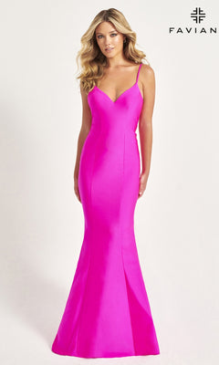 A woman wears the Faviana Classic Mermaid Long Prom Dress 11047 in bright pink with thin straps and a V-neckline. The fitted, floor-length gown is shown against a plain white background with the Faviana logo in the top right corner.