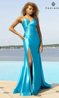 A woman in a turquoise Faviana Lace-Up Long Satin Prom Dress 11051 with a thigh-high slit stands by a pool, water and trees behind her. "FAVIAN" is visible in the top right corner.