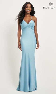 A woman models the Faviana Twist-Knot Long Satin Prom Dress 11066 in light blue, featuring a twisted front detail, standing against a white background with the Faviana logo in the top right corner.