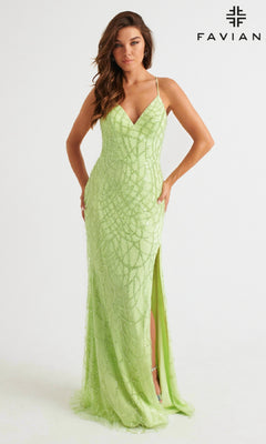 A woman models the Glitter Faviana Long Strappy-Back Prom Dress 11084 in light green, featuring spaghetti straps and a thigh-high slit, against a white background. The Faviana logo is visible in the upper right corner.