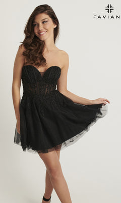 A woman models the Faviana 11120 short black lace homecoming dress, strapless with embroidered lace, posing against a white background and holding her skirt. The "Faviana" brand name and logo are shown in the top right corner.