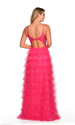 A woman stands against a white background wearing the Dave and Johnny Long Tiered Prom Dress 11148, featuring a sleeveless, bright pink design with an open back and lace v-neck bodice.