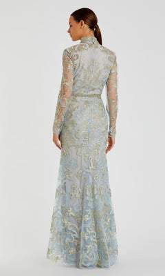 A woman is shown from the back wearing the Mac Duggal 11165 Long Sleeve Lace Formal Gown, a vintage-style evening dress with a high neck and intricate gold and blue lace embroidery.