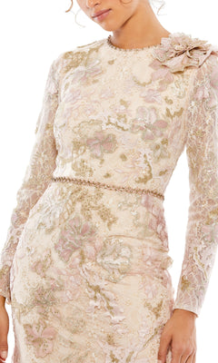 A woman wearing the Long Formal Dress 11174 by Mac Duggal, featuring long sleeves, floral lace embroidery, a beaded belt, and a decorative fabric flower on the shoulder.