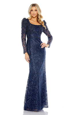 A woman stands against a white background wearing the Mac Duggal 11187 Long Sleeve Long Formal Gown—a navy blue evening dress with lace and intricate details, ideal as a mother of the bride outfit.
