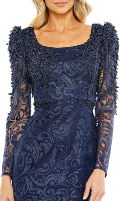 A woman wears the Mac Duggal 11187 long sleeve navy formal gown, featuring intricate lace and leaf-like textured embellishments on the sleeves and bodice—an ideal choice for an evening event or as a mother of the bride dress.