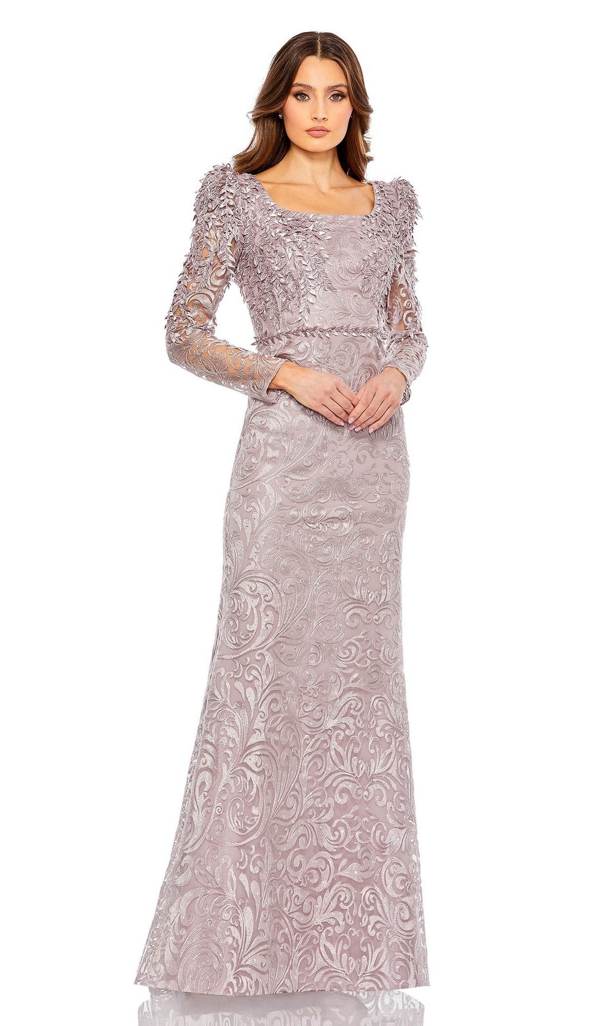 A woman wears the Mac Duggal 11187 Long Sleeve Long Formal Gown, a light mauve evening dress with a fitted bodice, textured patterns, and sheer sleeves—ideal as a mother of the bride dress—against a white background.