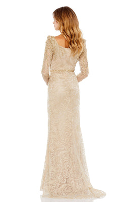 Woman stands with her back to the camera in the elegant Mac Duggal 11187—a long sleeve formal gown featuring gold lace and intricate patterns, perfect as a sophisticated mother of the bride dress.