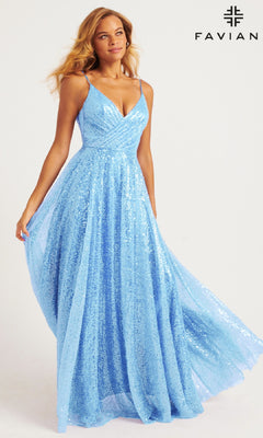 A woman in the Faviana 11203 Long Sequin A-Line Prom Dress, sparkling in light blue with thin straps, stands near the "FAVIAN" logo against a plain background.