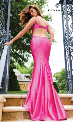 A woman stands on outdoor stairs, looking over her shoulder in the Faviana 11217 long prom dress—a bright pink, stretch satin gown with an elegant open-back design. The "Faviana" brand name appears in the upper right corner.
