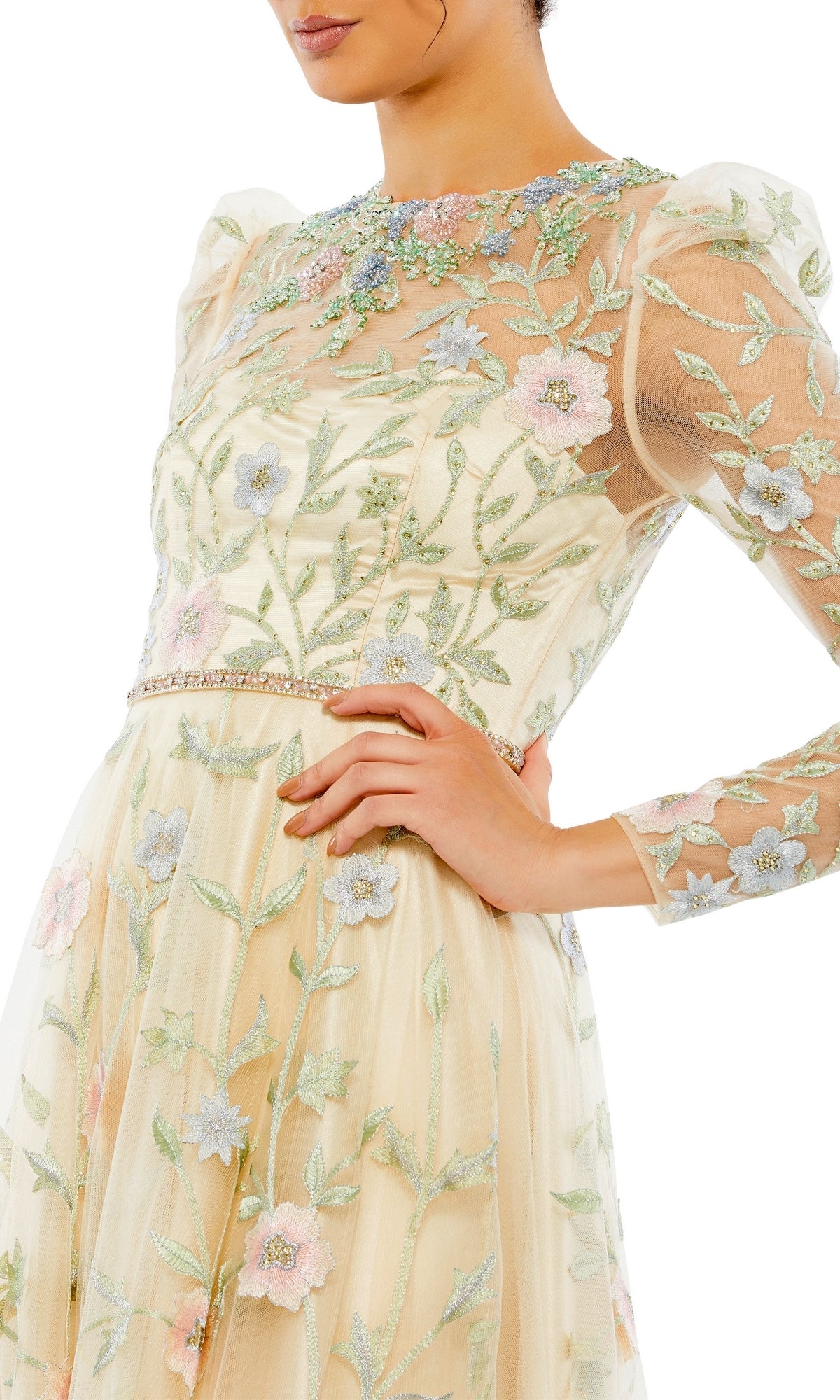 A woman poses with hand on hip in the Long Formal Dress 11226 by Mac Duggal—a sheer, light yellow A-line dress with floral embroidery and puff sleeves—set against a white background.