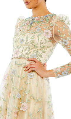 A woman poses with hand on hip in the Long Formal Dress 11226 by Mac Duggal—a sheer, light yellow A-line dress with floral embroidery and puff sleeves—set against a white background.