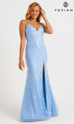 Woman wearing Faviana 11229 Shimmer Tulle V-Neck Prom Dress in light blue, featuring thin straps, floral embroidery, and a front slit. Faviana logo appears in the top right corner.