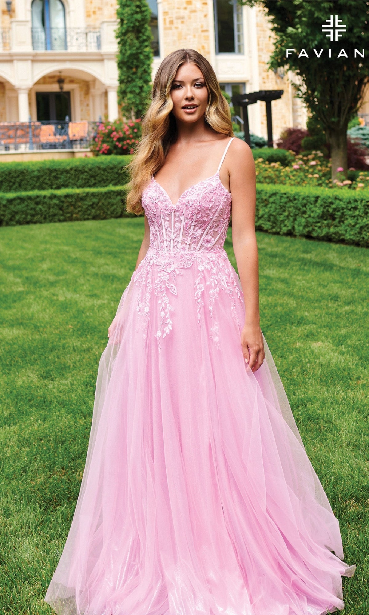A woman stands on grass before a building, wearing the Long Lace-Bodice A-Line Prom Dress: Faviana 11230 in pink. 
