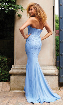 Woman with curly hair wearing the Faviana 11234 Deep V-Neck Long Halter Prom Dress, a light blue floor-length gown, standing outdoors and facing away from the camera.