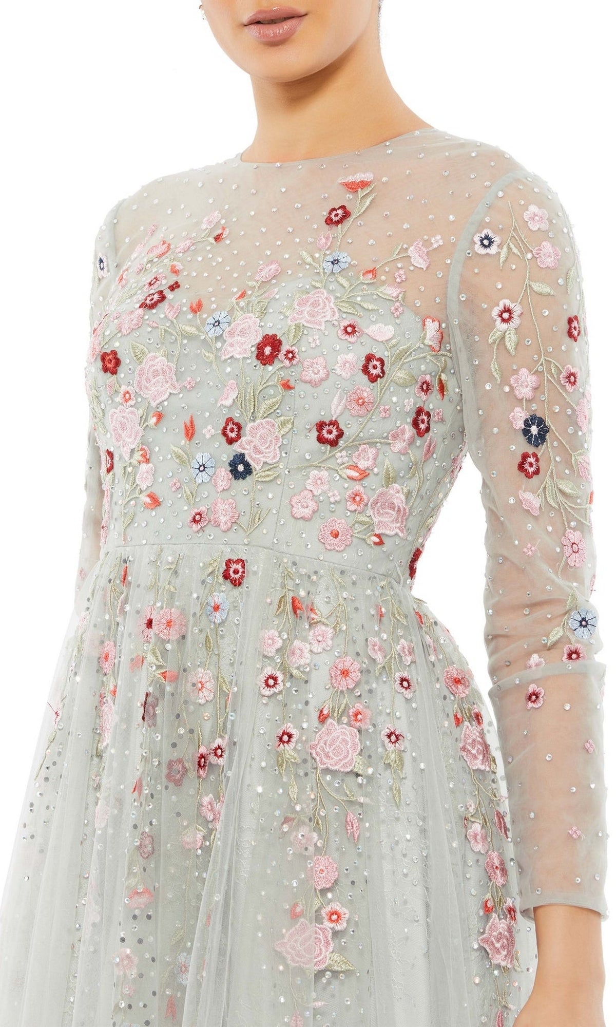 A woman wearing the Long Formal Dress 11241 by Mac Duggal, featuring sheer long sleeves and detailed pink, red, and white floral embroidery accented with pearls.