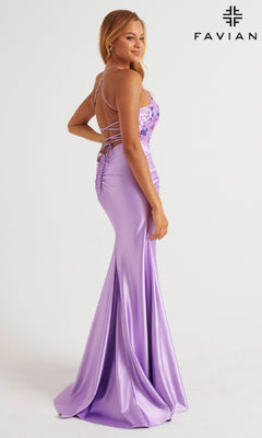 A woman wears the Faviana 11252 long prom dress in lavender, featuring bodycon stretch satin, floral beaded applique, a fitted bodice, and an adjustable lace-up open back. The "FAVIANA" brand name appears in the top right corner.
