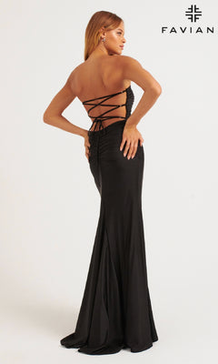 A woman models Faviana 11266, a black, backless long prom dress with a high leg slit and lace-up back, standing against a plain background with the "FAVIAN" logo in the top right corner.