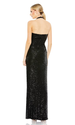 A woman faces away, wearing the Long Black Sequin Halter Prom Dress 11279 by Mac Duggal, featuring a halter neckline, sequins, and a fitted silhouette; her hair is styled in a low ponytail.