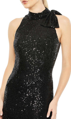 A woman wears the Mac Duggal 11280 Bow Long Sequin Formal Dress—a sleeveless, black gown with a high neckline and bold shoulder bow—ideal for an elegant evening look.