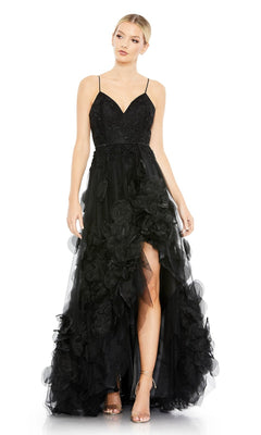 A woman stands with her hands by her sides wearing the Mac Duggal 11293, a long black formal dress featuring spaghetti straps, a sweetheart neckline, a fitted bodice, and layered floral details.