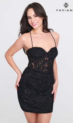A woman poses against a plain background wearing the Faviana 11301 Strappy-Back Short Lace Hoco Dress, with the Faviana logo in the top right corner.