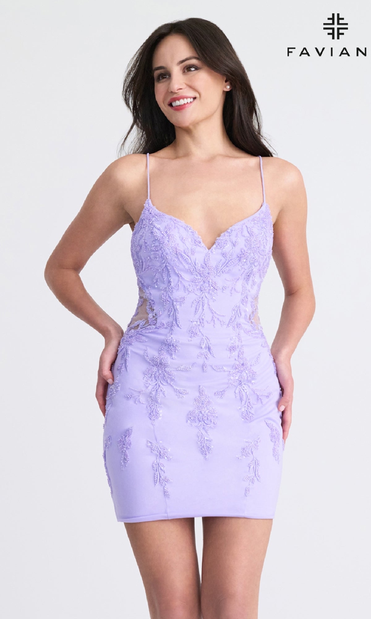 A woman smiles against a plain background in the Faviana 11303 Short Beaded Homecoming Dress—a fitted, light purple, sleeveless mini dress with floral embroidery and open back. 