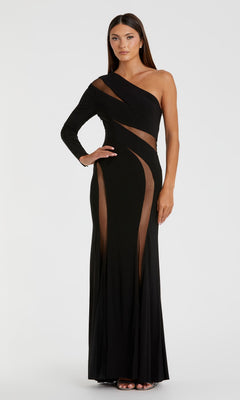 A woman models the Cut-Out Long Black Formal Dress: Mac Duggal 11311, featuring sheer mesh cutouts and a single long sleeve, while posing gracefully against a plain white background.