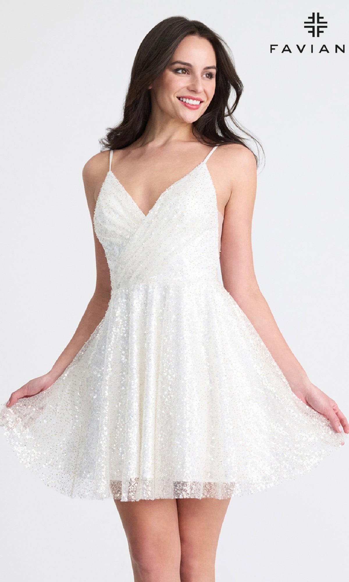 A woman smiles against a plain background in the Short A-Line Sequin Hoco Dress: Faviana 11319 with spaghetti straps. The 