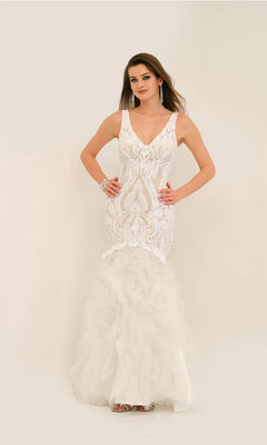 A woman models the Long Formal Dress 11325 by Dave and Johnny—sleeveless, white, with a v-neckline, intricate lace details, and a ruffled tulle skirt—standing against a plain light background.
