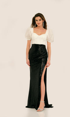 A woman models the Long Formal Dress 11328 by Dave and Johnny—a black sequin floor-length gown with a thigh-high slit—paired with silver heels and drop earrings, set against a plain background.