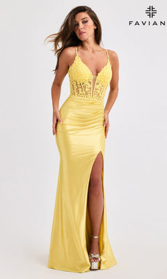 A woman in the Faviana 11400 long yellow satin prom dress with a lace corset bodice, high slit, and strappy heels stands against a plain background. "FAVIANA" and its logo are shown in the top right corner.