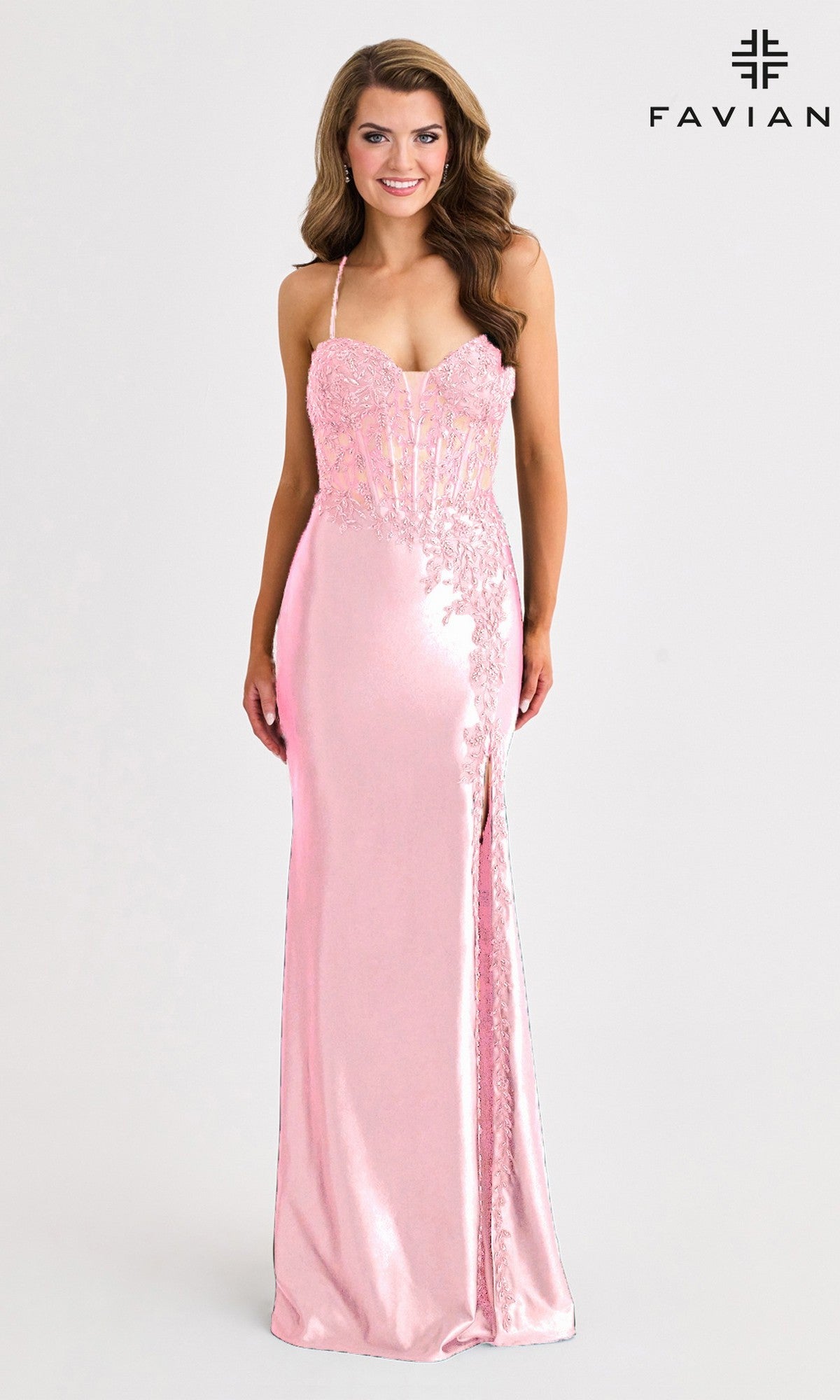 A woman wears the Faviana 11404 long prom dress—floor-length, light pink satin with lace details, thin straps, sweetheart neckline, corset bodice, and front slit; 
