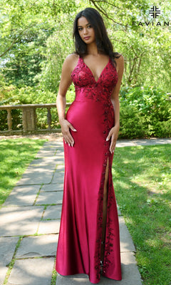 A woman stands outdoors wearing the Faviana 11405 long prom dress, showcasing floral embroidery, a thigh-high slit, and an elegant strappy open back.