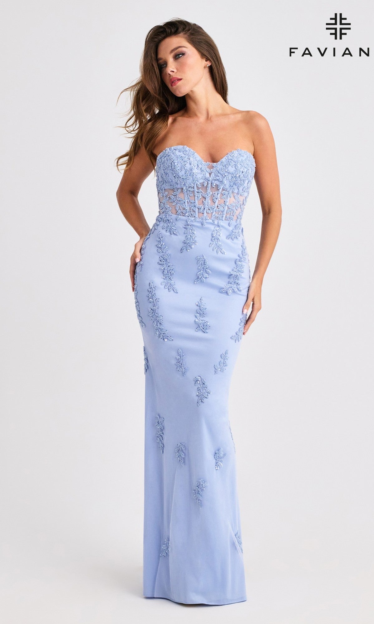 A woman models the Faviana 11407 long prom dress in light blue, featuring a strapless lace corset bodice and a fitted, floor-length silhouette; 