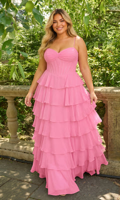 A person wears a cotton candy pink Long Plus-Size Prom Dress: Faviana 11420E, featuring a corset-style bodice and a tiered, chiffon ruffle skirt.