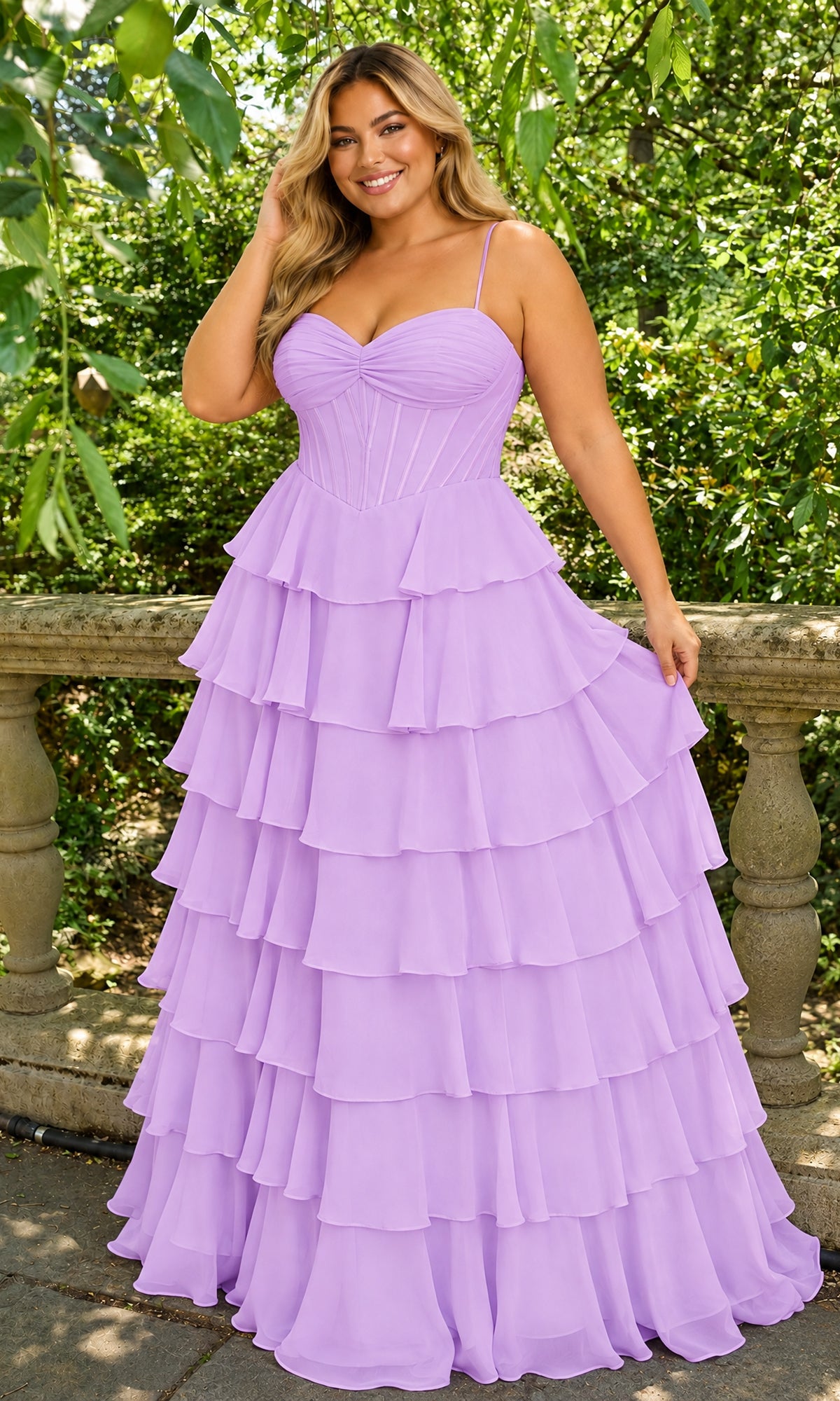 A smiling woman wears a bright lilac Long Plus-Size Prom Dress: Faviana 11420E, featuring a sweetheart corset-style bodice and a multi-tiered ruffled chiffon skirt.