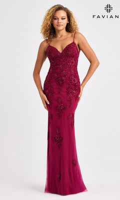 A woman wears the Faviana 11428 long prom dress in burgundy, featuring intricate floral beaded applique, a sleeveless design, and an elegant open back, against a plain light background. The Faviana logo appears in the top right corner.