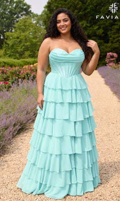 A plus-size woman wears a sea glass Faviana 11436E prom dress with a strapless corset bodice and a tiered ruffled chiffon skirt.