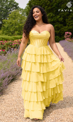 A woman walks along a gravel garden path wearing a Faviana 11436E Long Plus-Size Prom Dress, a light yellow strapless gown featuring a corset bodice and a tiered ruffled chiffon skirt.