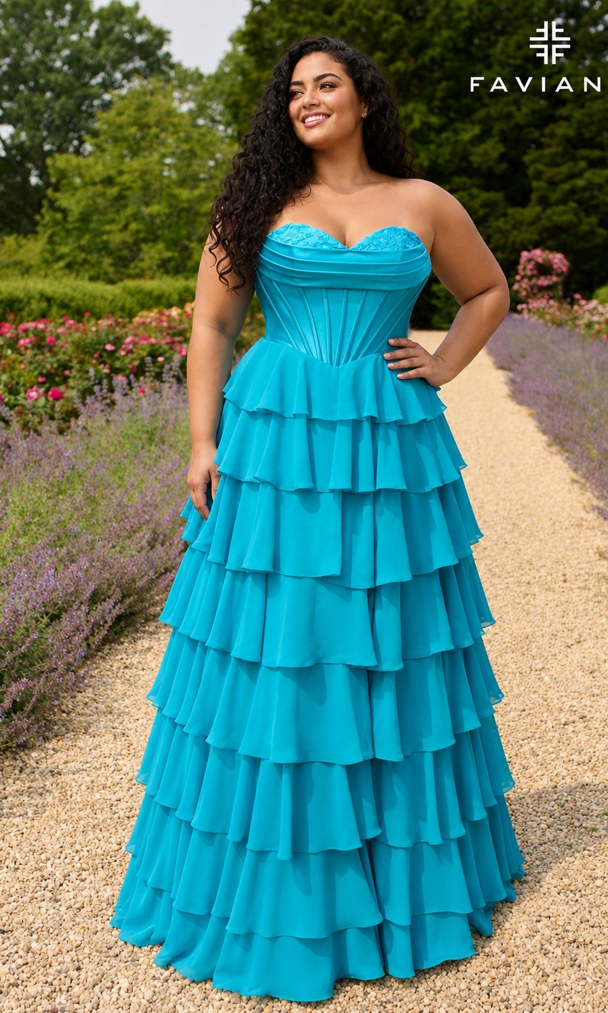 A person wears a Long Plus-Size Prom Dress: Faviana 11436E, a strapless, aqua, floor-length gown featuring a lace bodice and a multi-tiered ruffled chiffon skirt.