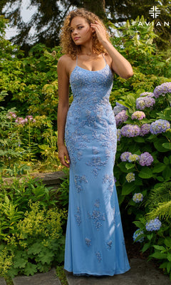 A woman wearing the Faviana 11440 long prom dress in fitted light blue with beaded applique stands outdoors among blooming hydrangeas and lush greenery.