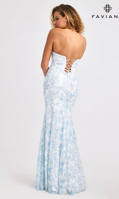 A woman models the Faviana 11441 Long Prom Dress—a light blue floral sequin mermaid gown with a strapless lace-up back—standing before a plain white backdrop featuring the FAVIAN logo in the top right corner.