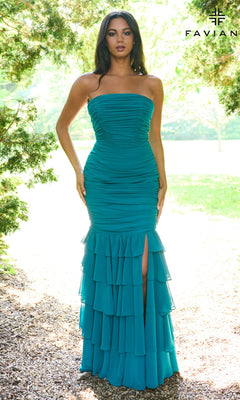A woman stands outdoors in a teal Faviana 11457 long prom dress with a strapless ruched bodice, tiered ruffle skirt, and front slit. Sunlight filters through the trees behind her. FAVIAN logo appears in the top right corner.